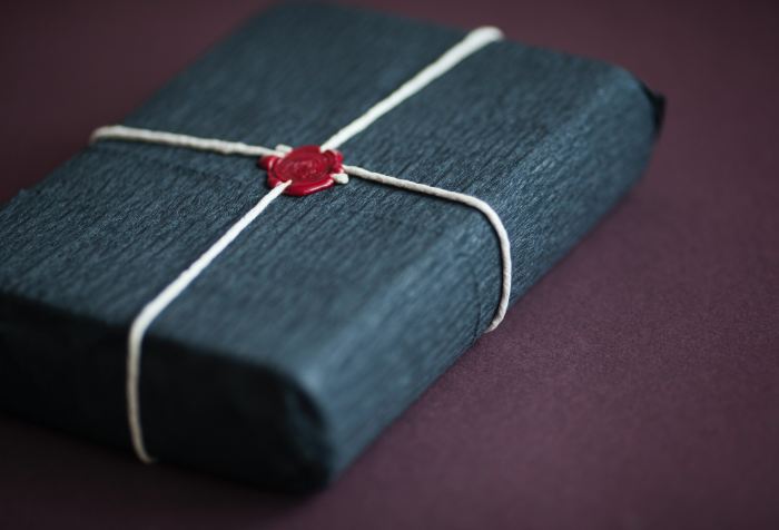 The gift of a book wrapped with twine and sealed with a red seal